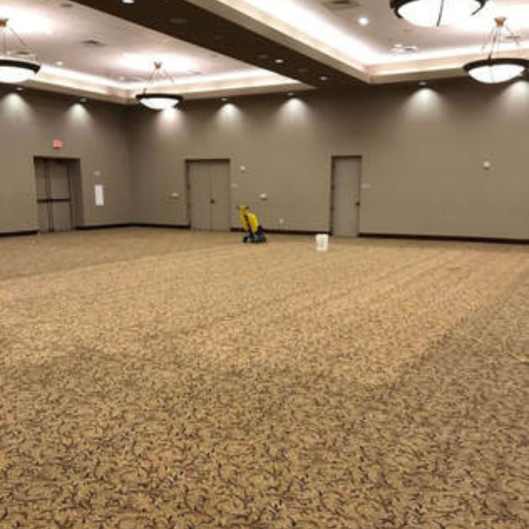 Surprise Carpet Cleaning Co. crew cleaning carpet in a large commercial conference room