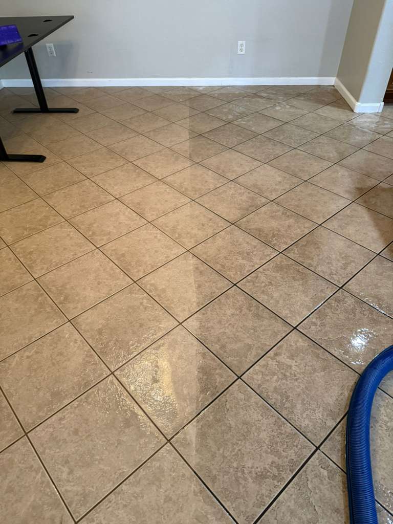 Surprise Carpet Cleaning Co. tile floor cleaning with hose, before-and-after visible